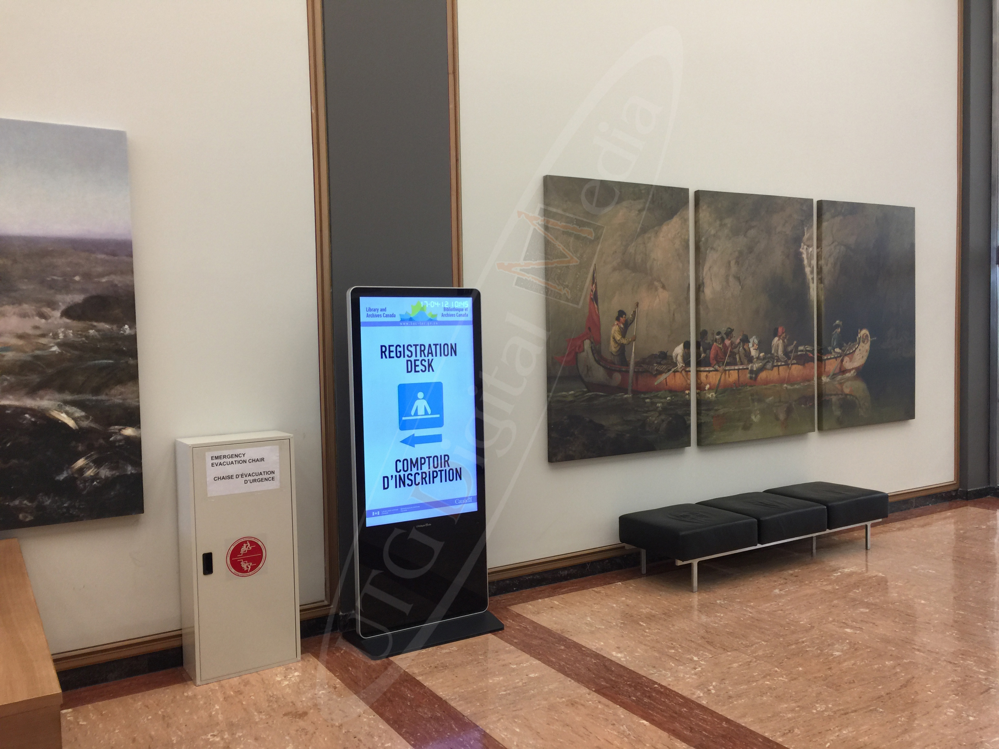 A UTG LCD Standup Screen in the entrance lobby of The Library & Archives