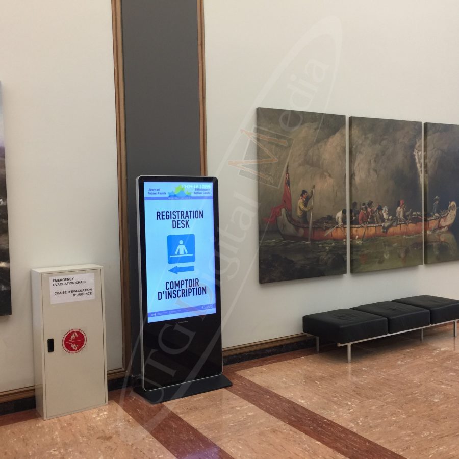 A UTG LCD Standup Screen in the entrance lobby of The Library & Archives